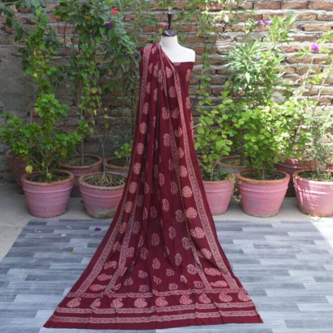 Ajrak Red Anbi Organic Dye Hand Block Printed unstitched two-piece dress featuring a deep red shirt and dupatta with intricate geometric and floral motifs, showcasing traditional craftsmanship.