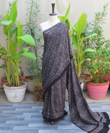 Ethnic Ajrak Saree in black with intricate hand block printed geometric and floral patterns, crafted in eco-friendly Modal Silk for elegance and comfort.