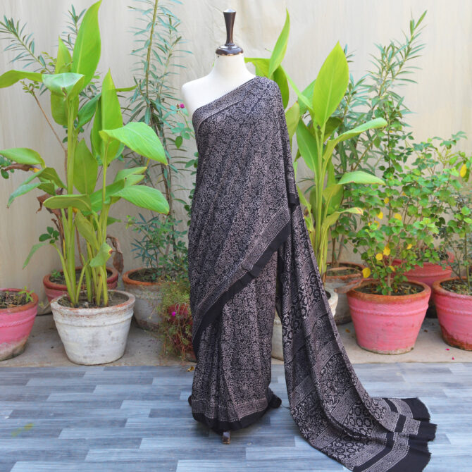 Ethnic Ajrak Saree in black with intricate hand block printed geometric and floral patterns, crafted in eco-friendly Modal Silk for elegance and comfort.