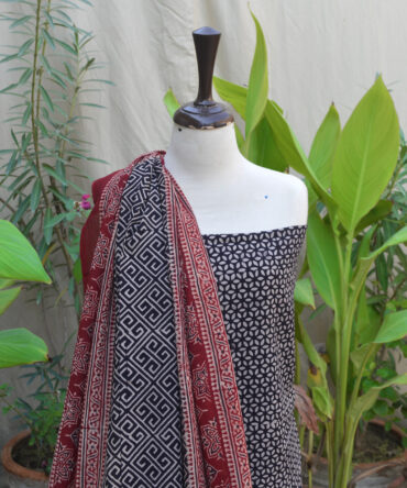 Artisan hand block printing the Ajrak Patti Floral Classic dress, showcasing traditional craftsmanship techniques.