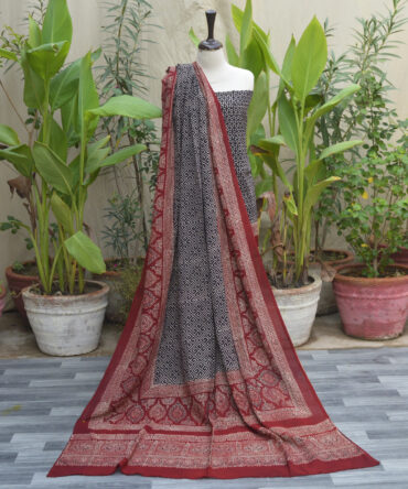 The Ajrak Patti Floral Classic Organic Dye Hand Block Printed Dress featuring a black and red floral design with a matching dupatta.