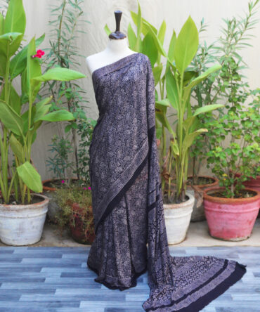 Ajrak Saree Anbi Floral in Black with hand block printing, showcasing traditional geometric and floral patterns in deep tones, crafted in breathable Modal Silk for a sophisticated, eco-friendly look.