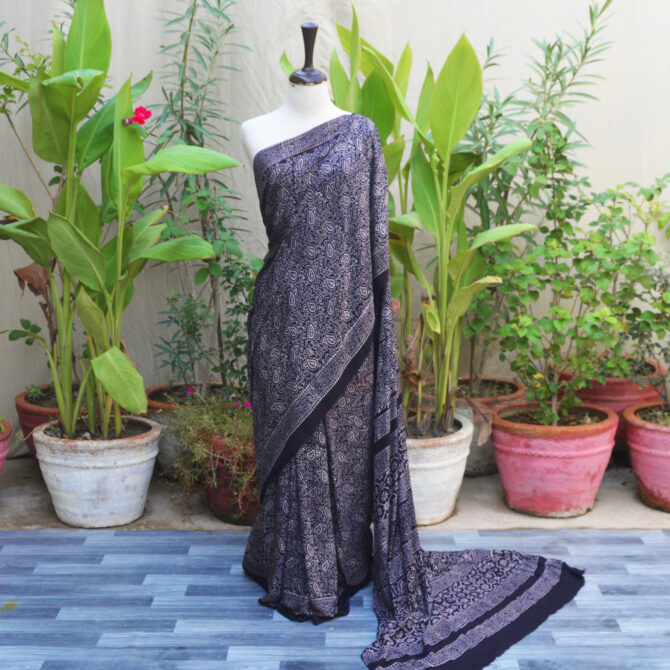 Ajrak Saree Anbi Floral in Black with hand block printing, showcasing traditional geometric and floral patterns in deep tones, crafted in breathable Modal Silk for a sophisticated, eco-friendly look.