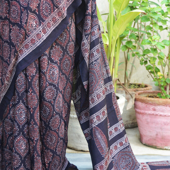 Close-up of the Ethnic Ajrak Saree Sundaree, featuring detailed traditional Ajrak motifs on fine fabric. The saree is a sophisticated mix of cultural craftsmanship and modern style.