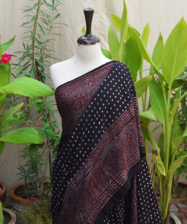 Ethnic Ajrak saree with polka dots, showcasing a blend of traditional Ajrak printing and modern design elements.