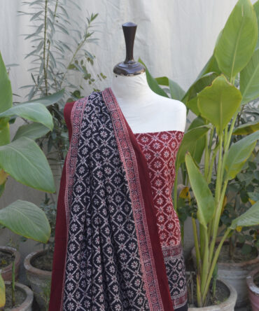 Close-up view of the red and black floral Ajrak hand block printed design, highlighting its traditional craftsmanship and organic dye finish.