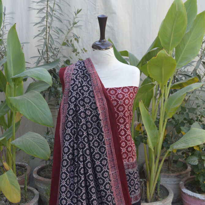 Close-up view of the red and black floral Ajrak hand block printed design, highlighting its traditional craftsmanship and organic dye finish.